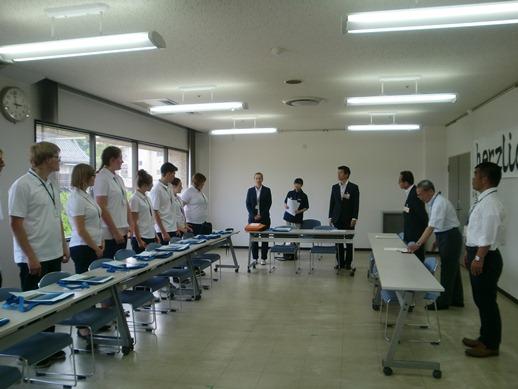 第41回日独スポーツ少年団同時交流にて挨拶をする市長と耳を傾ける参加者たちの写真