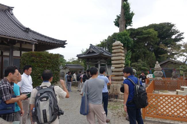 福王寺境内で石造物を前に見学する様子の写真