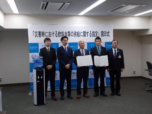 調印された協定書を持ちタイピック社長や社員らと記念撮影をしている市長の写真