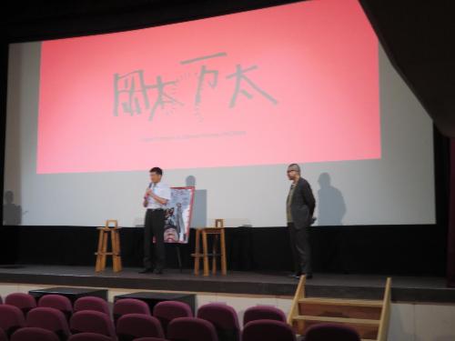 小野沢ビル3階映画館で真田監督とともに壇上に立ちトークショー参加者らに挨拶をしている市長の写真