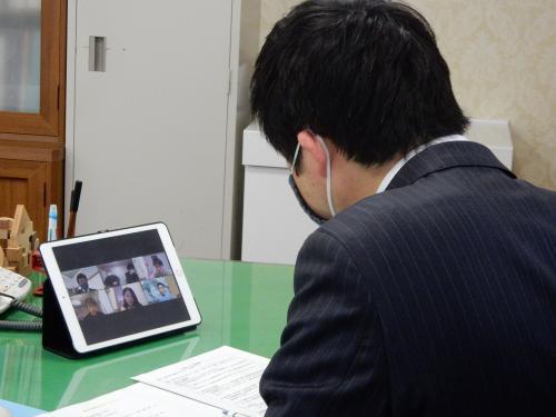 市長がタブレットを見ている写真