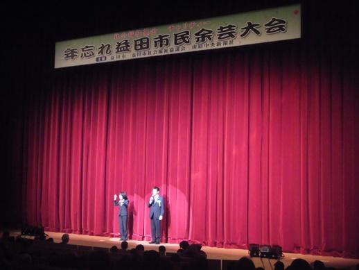 益田市民余芸大会にて緞帳前で挨拶する市長と手話通訳士の写真